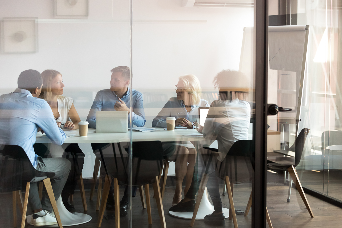 Business people negotiating at boardroom behind closed doors