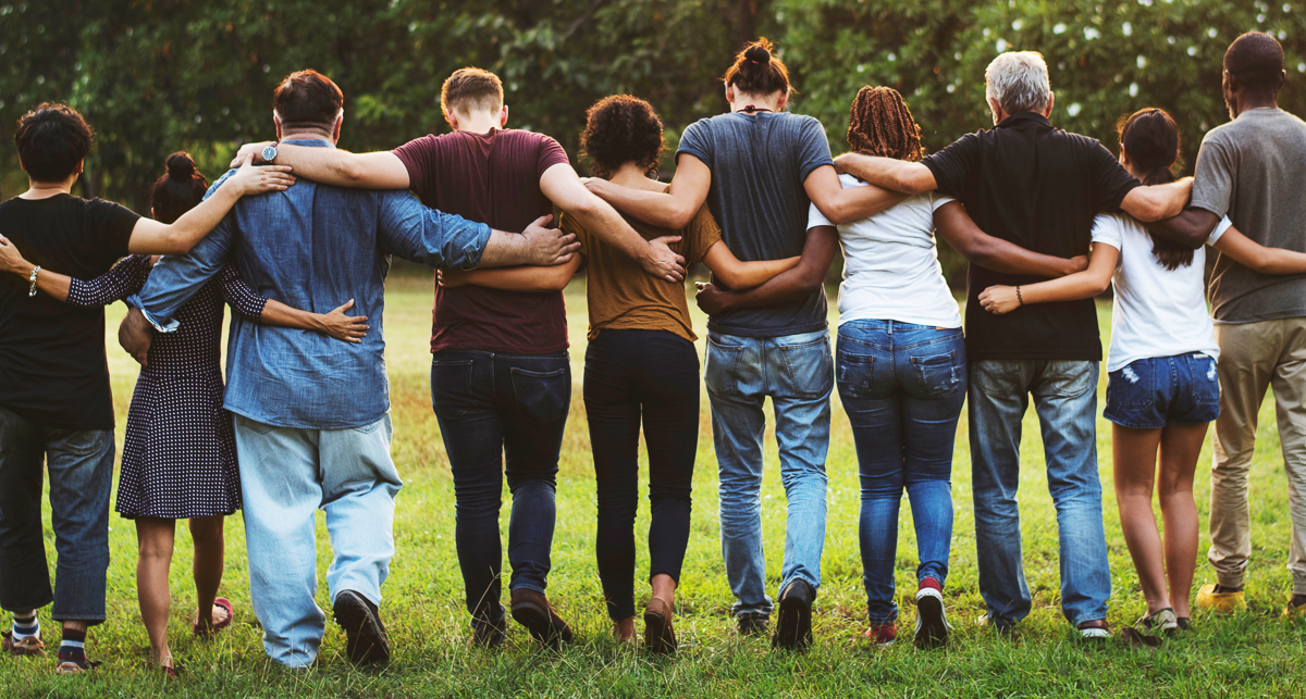 Group of friends huddle in rear view together