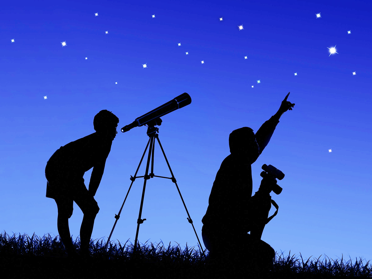 father and son study the starry sky